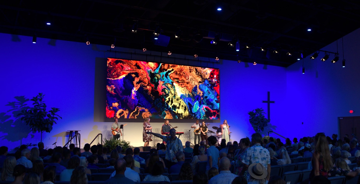 Church stage with an Altitude Cloud LED wall showing colorful visuals during worship