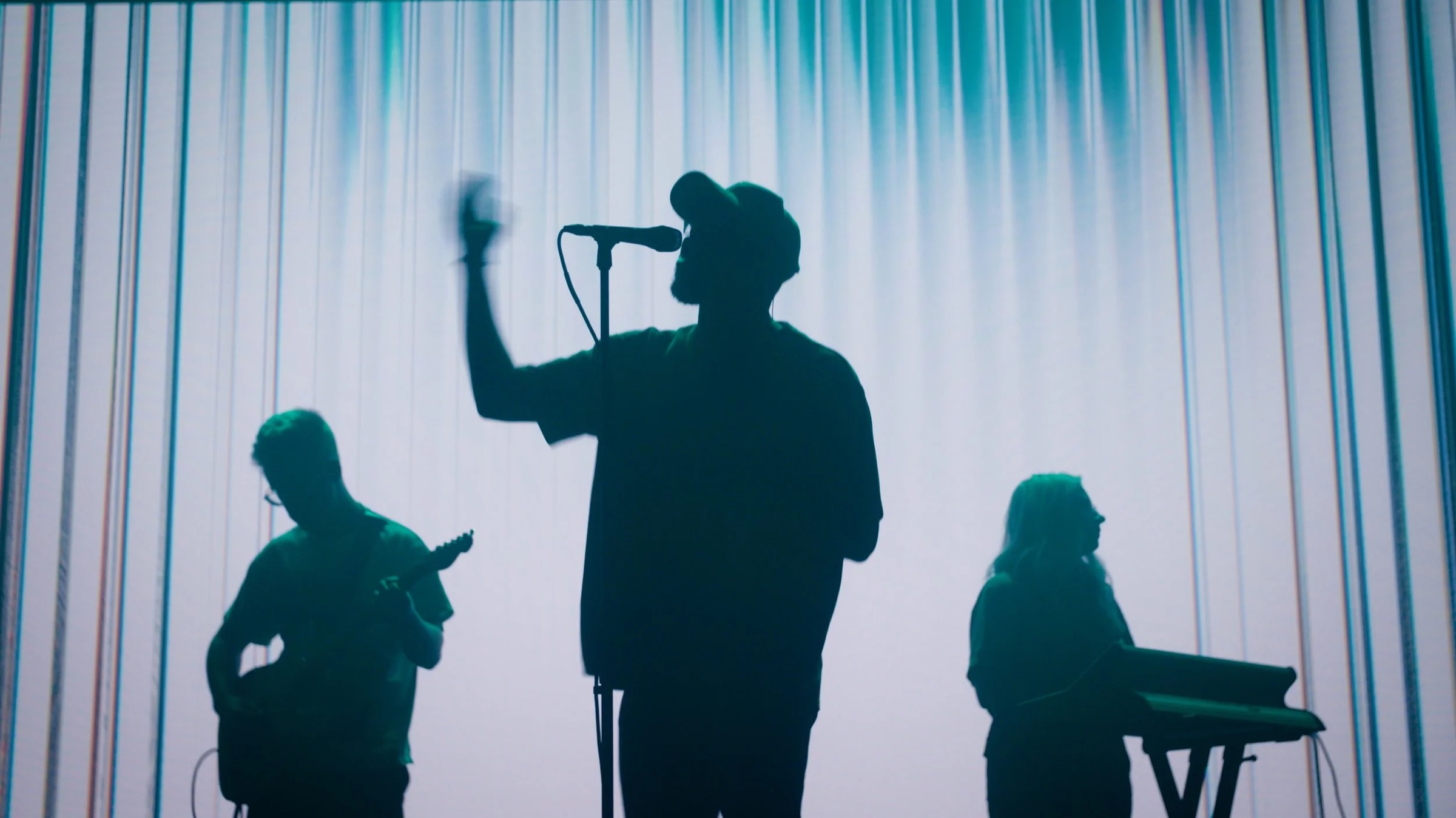 Silhouetted worship band performing in front of vertical LED lines